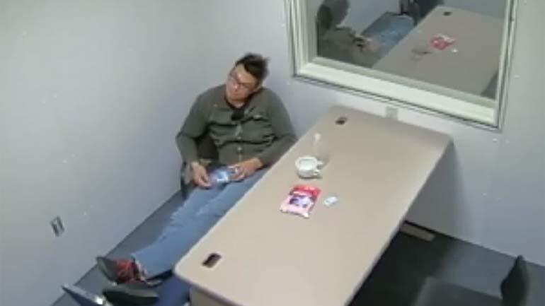 Dinh Bowman waits to be questioned by police