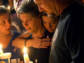 Diena Thompson, center, attends a candle-light vigil for her daughter Somer Thompson, Thursday, Oct. 22, 2009, in Orange Park, Fla.