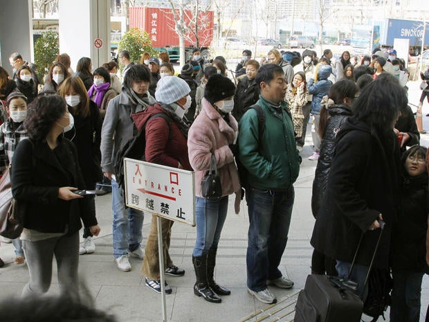 Foreigners wanted to flee line up for Japan re-entry permits
