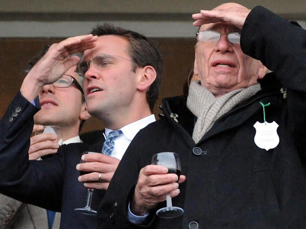 James Murdoch, left, and Rupert Murdoch are seen during the Cheltenham Festival at Cheltenham, England, March 18, 2010.