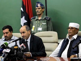 Mustafa Abdul-Jalil, center, the head of the interim government in Benghazi, delivers his statement to the press in the rebel-held town of Benghazi, Libya, July 28, 2011. Libya's rebel leadership council says its military commander has been killed. The National Transitional Council announced the death of Abdel-Fattah Younis July 28, 2011, hours after he was arrested by the rebels for questioning about suspicions his family still had ties to Muammar Qaddafi's regime.
