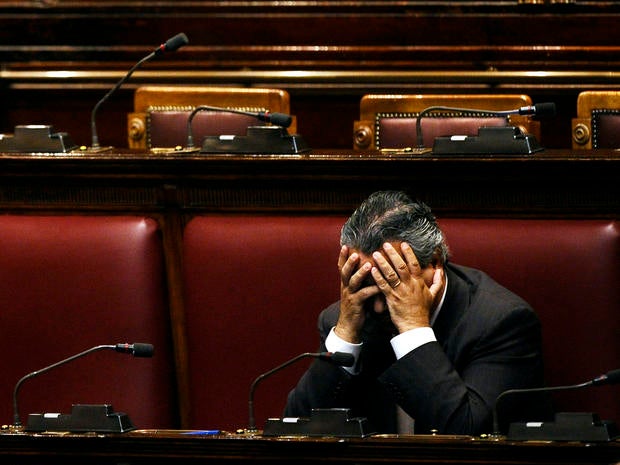 An unidentified deputy sits in an empty Italian Lower House before a debate to approve the last package of economic reforms in Rome Nov. 12, 2011.