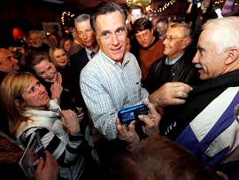 Former Massachusetts Gov. Mitt Romney makes his way through a crowd during a campaign stop at Old Salt Restaurant in Hampton, N.H., Dec. 31, 2011.