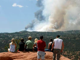 People watch as smoke billows from a wildfire west of Colorado Springs, Colo. on Saturday, June 23, 2012.