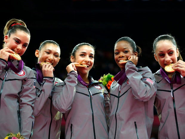 U.S. gymnasts McKayla Maroney, Kyla Ross, Alexandra Raisman, Gabrielle Douglas and Jordyn Wieber bite their gold medals at the artistic gymnastics women's team final at the 2012 Summer Olympics July 31, 2012, in London.