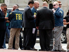 Washington police and FBI agents gather outside the Family Research Council in Washington Aug. 15, 2012, after a security guard at the lobbying group was shot in the arm.