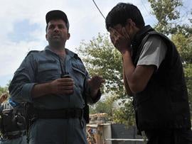 An Afghan man cries at the site of a suicide attack outside NATO headquarters in Kabul