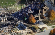 Citizens Energy workers continue their investigation Nov. 12, 2012, at the site of an explosion at a house in Indianapolis.