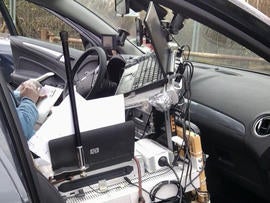 A vehicle with its interior wired up like a mobile office stopped on the autobahn.