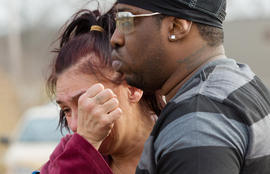 Kasmond Parker, right, consoles Cyndy Mann at the crash site where six teens were killed early in the morning on Park Ave. in Warren, Ohio on Sunday, March 10, 2013.