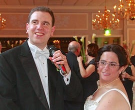In this April 7, 2103 photo provided by Bruce Presner, standing with his new wife, Hava Samuels, Paul Farziano sings to the audience on the coupleâ??s wedding day at East Wind in Wading River, NY.