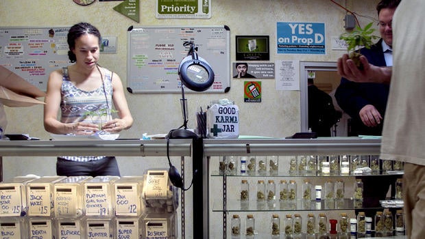 Nicole Denis, left, and Brennan Thicke, help fill medical marijuana prescriptions at the Venice Beach Care Center medical marijuana dispensary in Venice, Calif., on May 14, 2013.