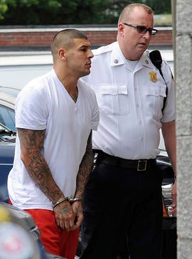 New England Patriots tight end Aaron Hernandez, left, is led into Attleboro District Court for court June 26, 2013, in Attleboro, Mass.
