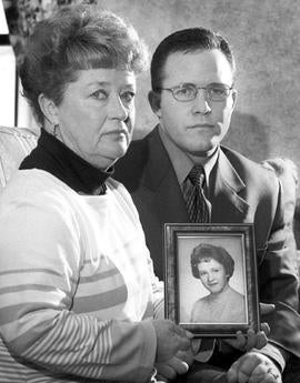 Diane Dodd and son Casey Sherman hold a picture of Dodd's sister Mary Sullivan in Rockland, Mass., March 10, 2000.