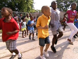 Kids play on the black top playground at the summer camp at New Mount Calvary Baptist Church in Chicago.