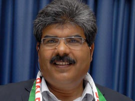 Tunisian lawmaker Mohammed Brahmi poses for photographers during a political meeting held in Tunis, Tunisia, in 2012.