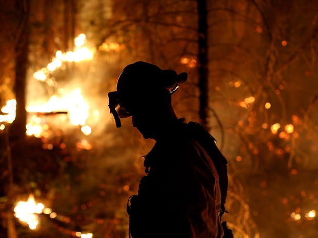 A firefighter from the Cosumnes Fire Department monitors a back fire while battling the Rim Fire Aug. 22, 2013, in Groveland, Calif., outside of Yosemite National Park.