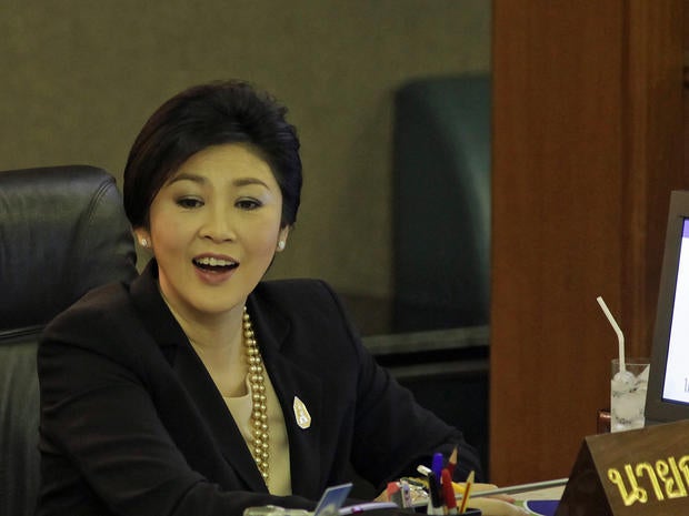 Thai Prime Minister Yingluck Shinawatra reacts after a no-confidence vote at the parliament in Bangkok