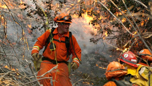A fire crew climbs a hill at the Colby Fire in Glendora, Calif., Jan. 16, 2014.