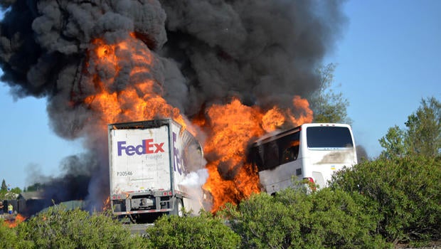 Massive flames are seen devouring a FedEx tractor-trailer and a bus just after they crashed near Orland, Calif., as clouds of smoke billow into the sky April 10, 2014.