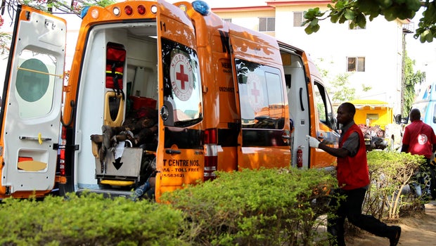 A Red Cross worker runs towards an ambulance carrying victims of a bomb blast at the Asokoro General Hospital in Abuja