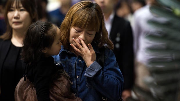 People attend a memorial for the victims of the sunken South Korean ferry Sewol at the Ansan Olympic memorial hall April 26, 2014.