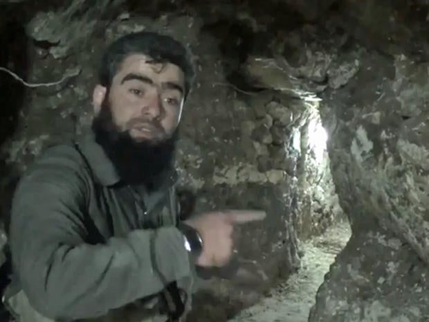 An image taken from video posted online in February, 2014 by the Syrian rebel group Islamic Front shows a militant in a tunnel allegeldy dug by the group underneath the Carlton Hotel in Aleppo