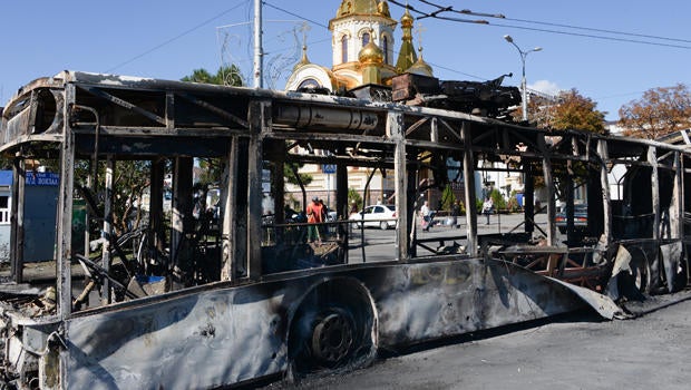 A burned trolleybus is seen near a Donetsk train station after shelling in Donetsk, Ukraine, Aug. 30, 2014.