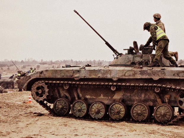 Ukrainian soldiers prepare for "live fire" exercises at a training center near Ukraine's border with Poland