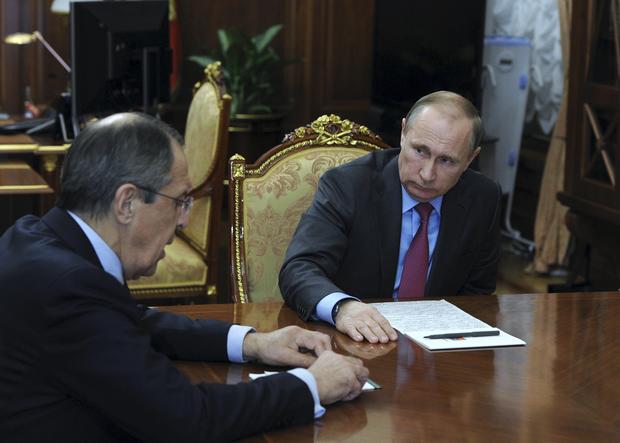 Russian President Vladimir Putin meets Foreign Minister Sergei Lavrov at the Kremlin in Moscow