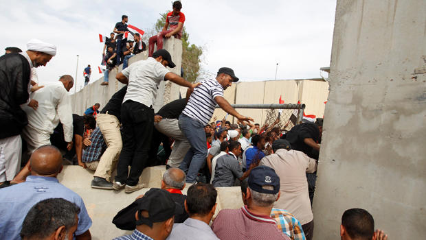 Followers of Iraq's Shiite cleric Muqtada al-Sadr storm Baghdad's Green Zone after lawmakers failed to convene for a vote on overhauling the government in Iraq April 30, 2016.
