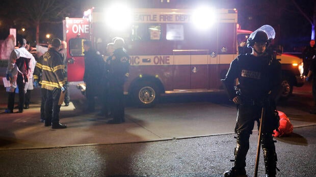 A Seattle Police officer is pictured near an ambulance where one person was shot at the University of Washington, where protesters arrived outside a speaking engagement by Breitbart News editor Milo Yiannopoulosin in Seattle, Washington, Jan. 20, 2017.