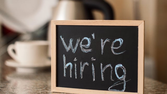 We'ra hiring notice on a small blackboard. Restaurant, cafe or bar background
