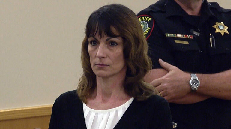 Michele Williams stands to hear the jury's verdict