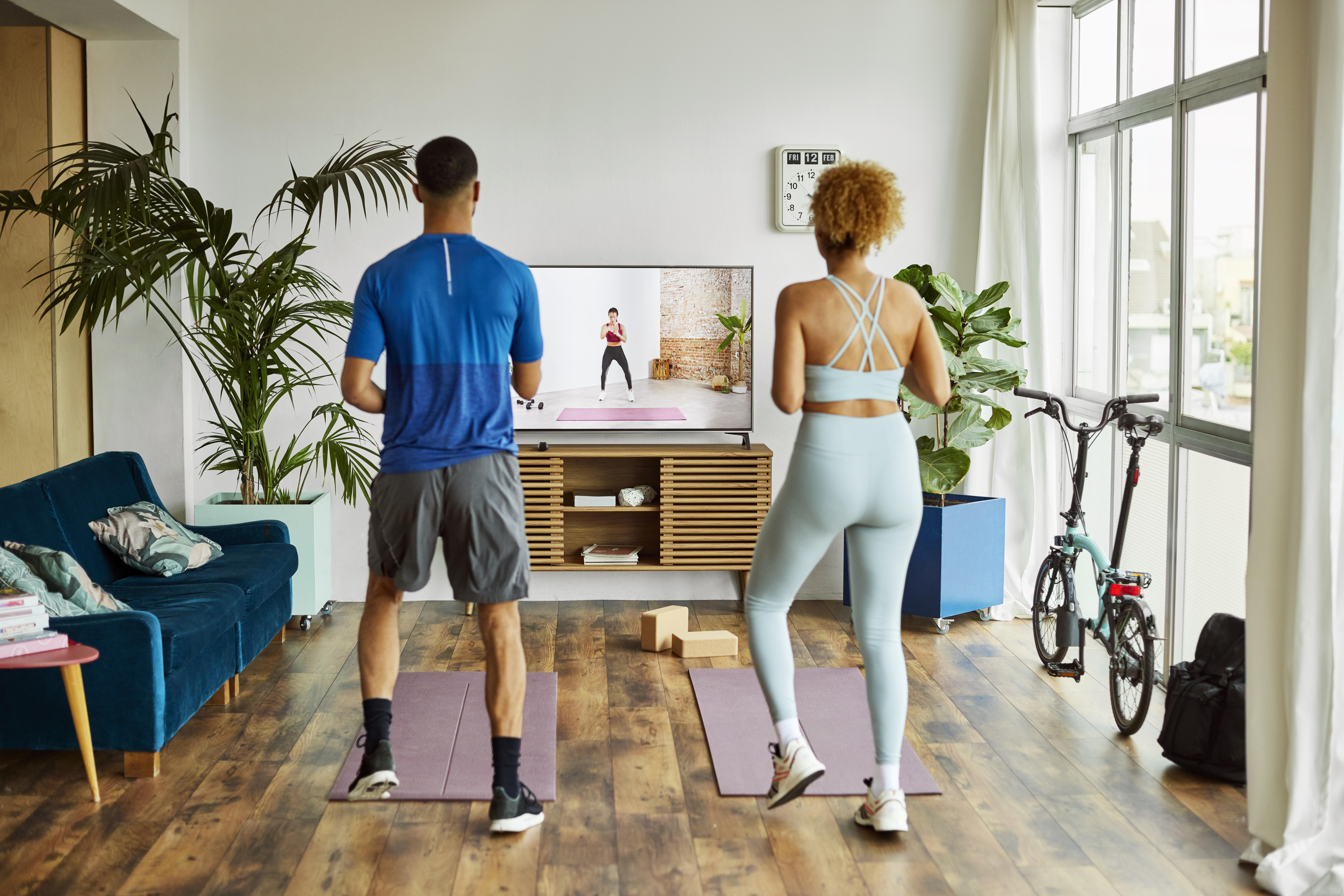 Couple Watching Online Exercise Class At Home 