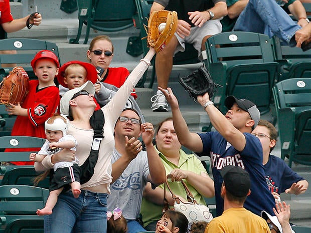 Tiffany Goodwin catches a foul ball in front of her husband