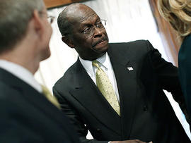 Republican presidential candidate Herman Cain leaves after a speech at the National Press Club October 31, 2011 in Washington, DC.