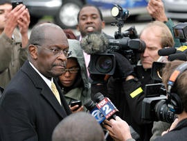 DETROIT, MI - OCTOBER 21: Republican presidential candidate Herman Cain speaks with the news media after unveiling his 'Opportunity Zone' economic plan in front of the Michigan Central Station, an abandoned train depot, October 21, 2011 in Detroit, Michigan. Cain has reportedly proposed changes to his '9-9-9' tax plan to exempt taxes for those living at or below the poverty line and businesses investing in 'Opportunity Zones'