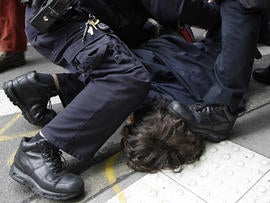 A police officer steps on the head of a demonstrator affiliated with the Occupy Wall Street movement as another arrests him Nov. 17, 2011, in New York.