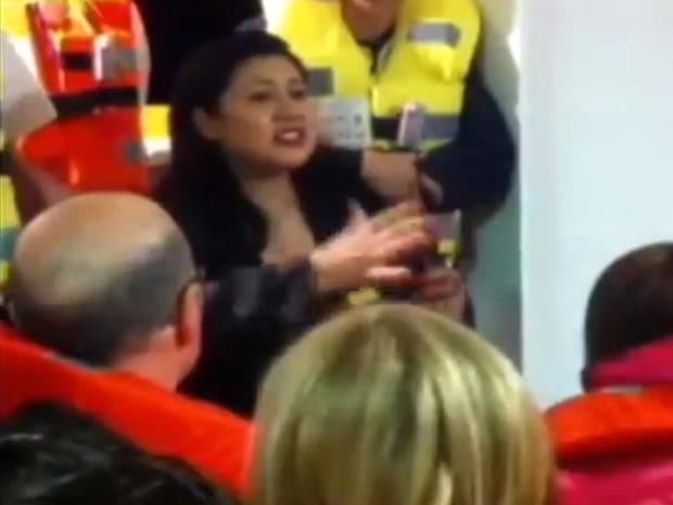 A Costa Concordia crew member reportedly asks in this screen grab taken from an Italian television report for passengers to return to their cabins after the cruise liner ran aground off Tuscany Jan. 13, 2012.