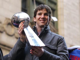 Eli Manning holds the Vince Lombardi Trophy