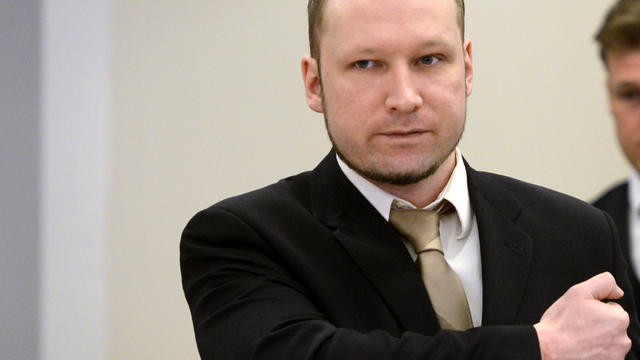 Right-wing extremist Anders Behring Breivik gestures as he arrives in Courtroom 250 at the central court of Oslo April 17, 2012, for the second day of his trial. 