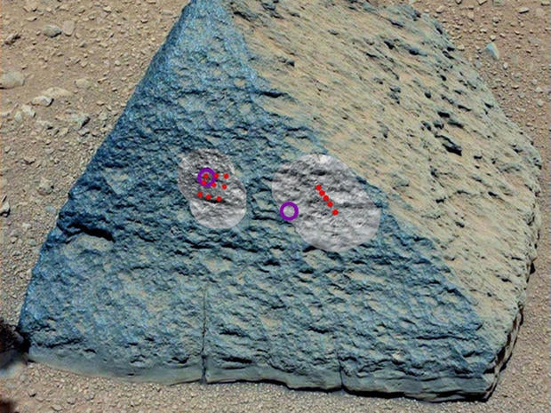 This image shows where NASA's Curiosity rover aimed two different instruments to study a rock known as "Jake Matijevic" in late September 2012. The red dots indicate where Curiosity fired its laser at the rock.