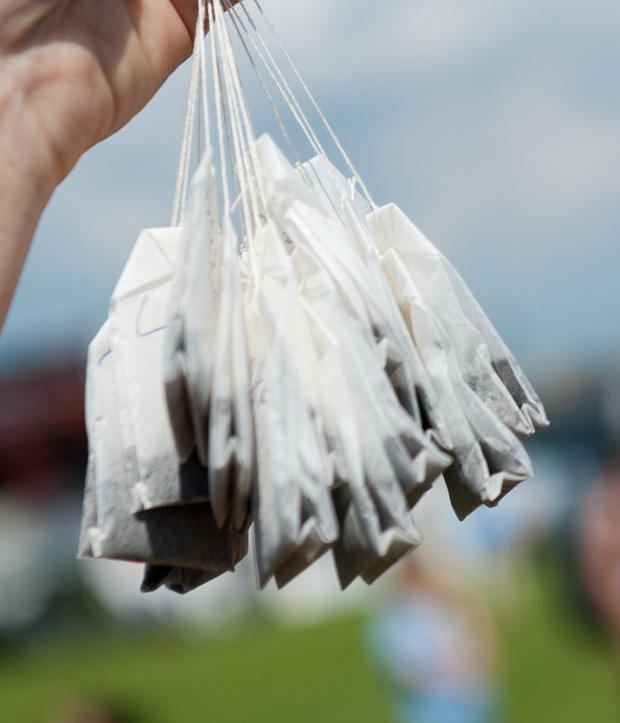 A participant holds up teabags at the Sl 