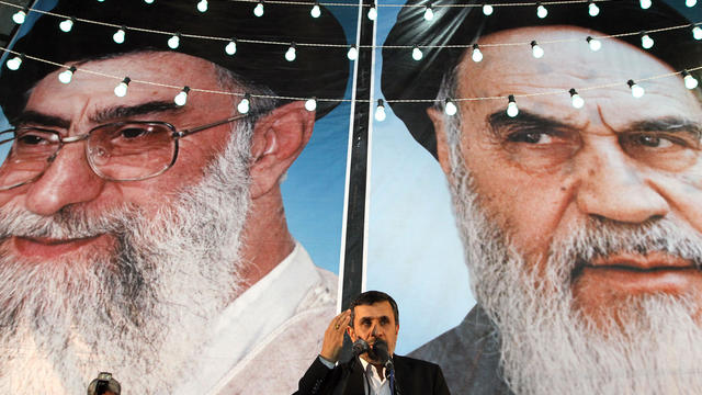 President Mahmoud Ahmadinejad delivers a speech under portraits of Iran's supreme leader, Ayatollah Ali Khamenei (L) and founder of the Islamic Republic of Iran, Ayatollah Ruhollah Khomeini 