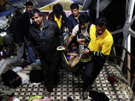 At least 30 people were crushed to death in a stampede as pilgrims tried to board a train.