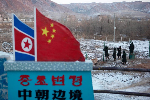 Chinese paramilitary police build a fence along the country's border withy North Korea.
