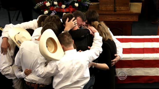 Mourners gather at the funeral for Mike and Cynthia McLelland.