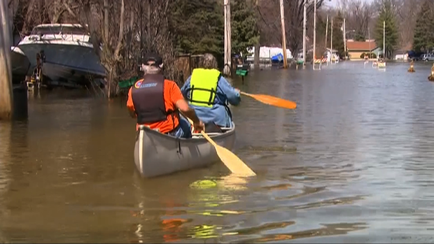 Two Fargo, N.D., residents get across the road via canoe. The Red River crested 16 feet above flood stage.