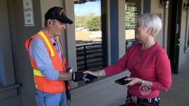 A woman shakes hands with Ric Ryan after donating money to UCLA's Operation Mend.
